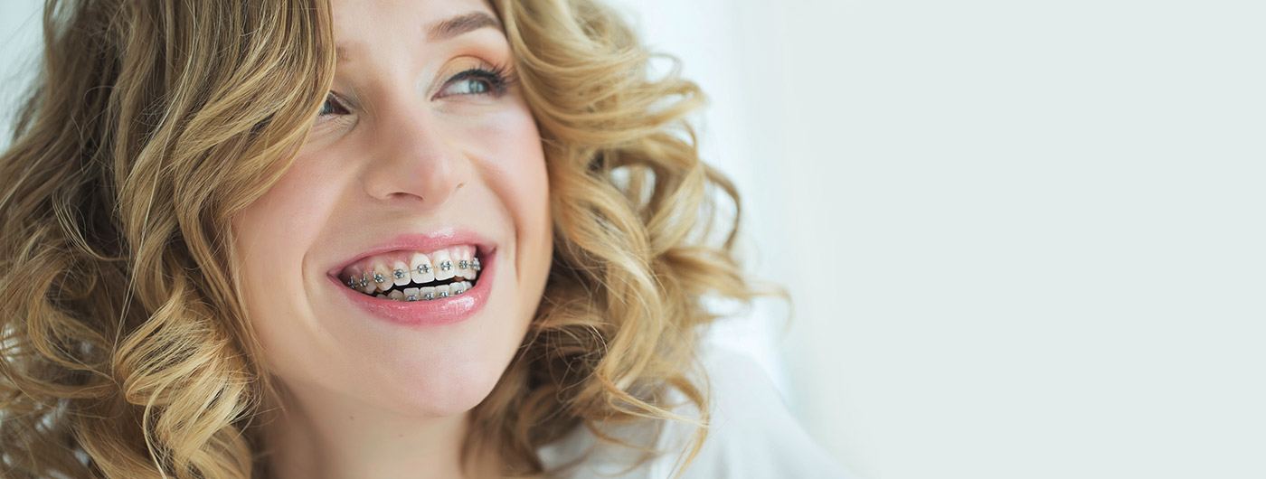 Smiling woman with traditional braces