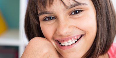 Preteen girl with orthodontic appliance